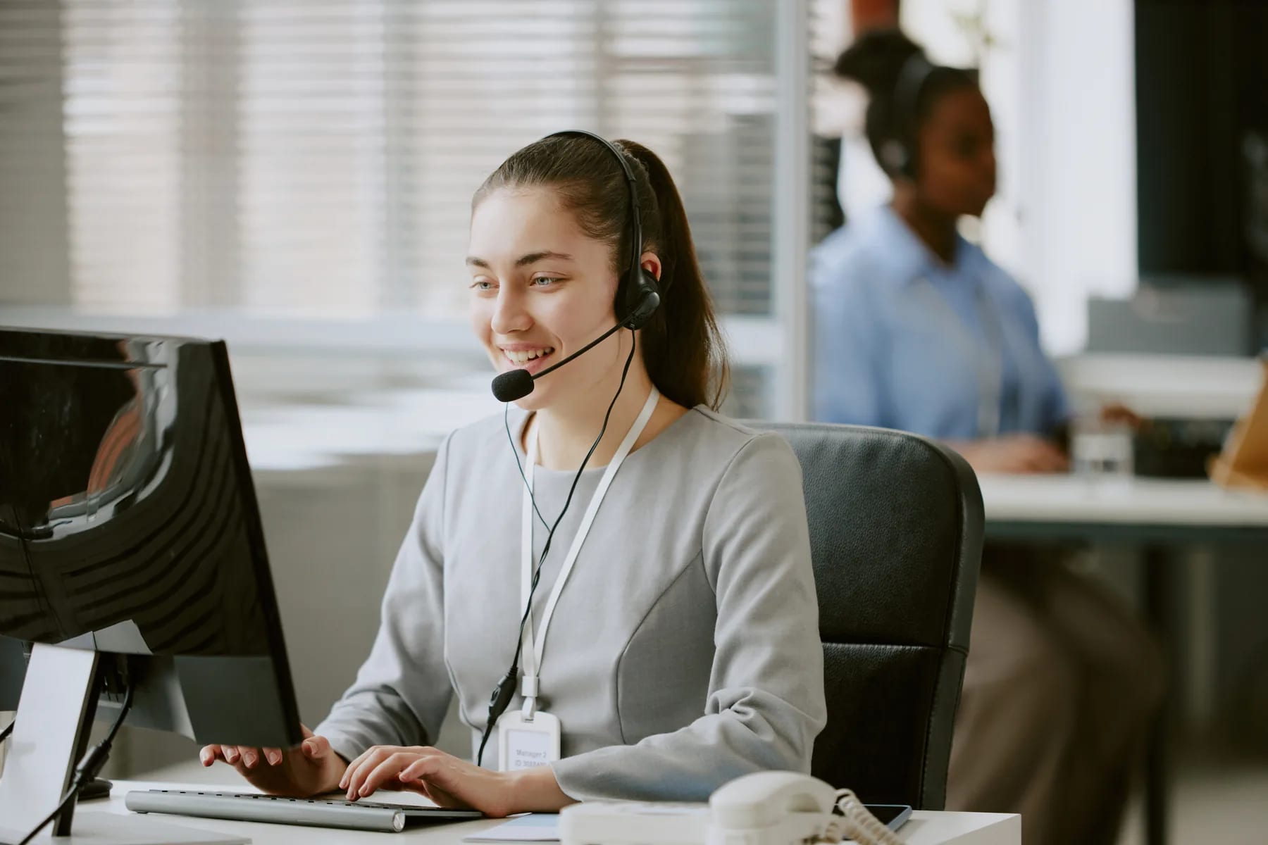 A support agent working a customer conversation from the service desk